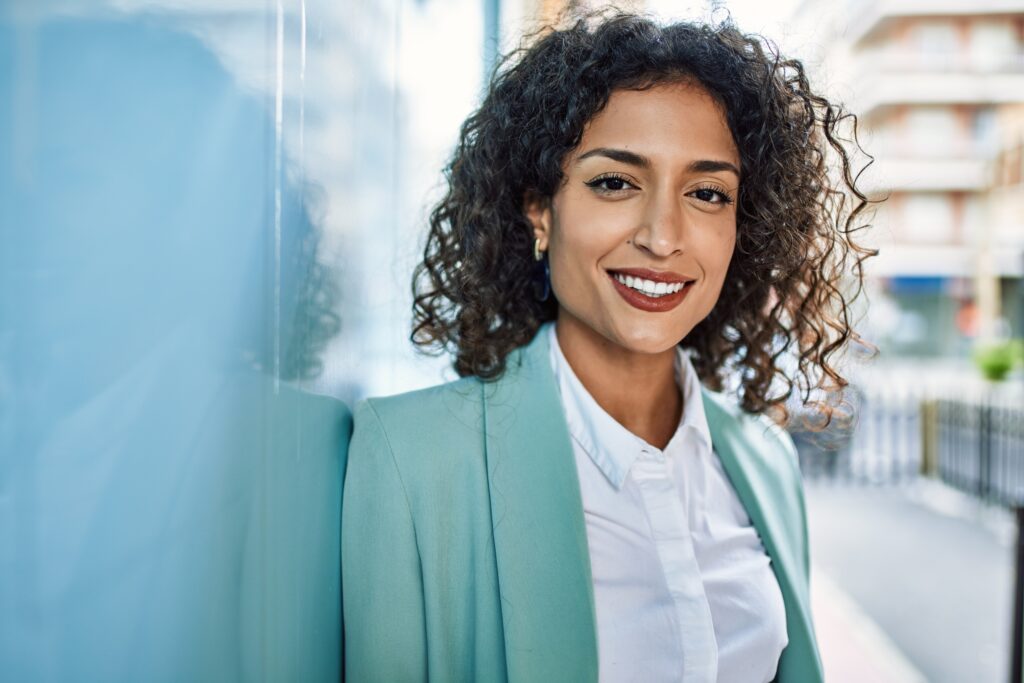 professional woman in suit jacket smiling at camera